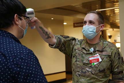 Airman 1st Class Conner Meling, 142nd Communications Flight, Portland Air National Guard Base, Ore., provides temperature screening services at Providence St. Vincent Medical Center. The Oregon National Guard mobilized 1,588 service members and provided over 300,000 labor hours at more than 20 hospitals across Oregon.