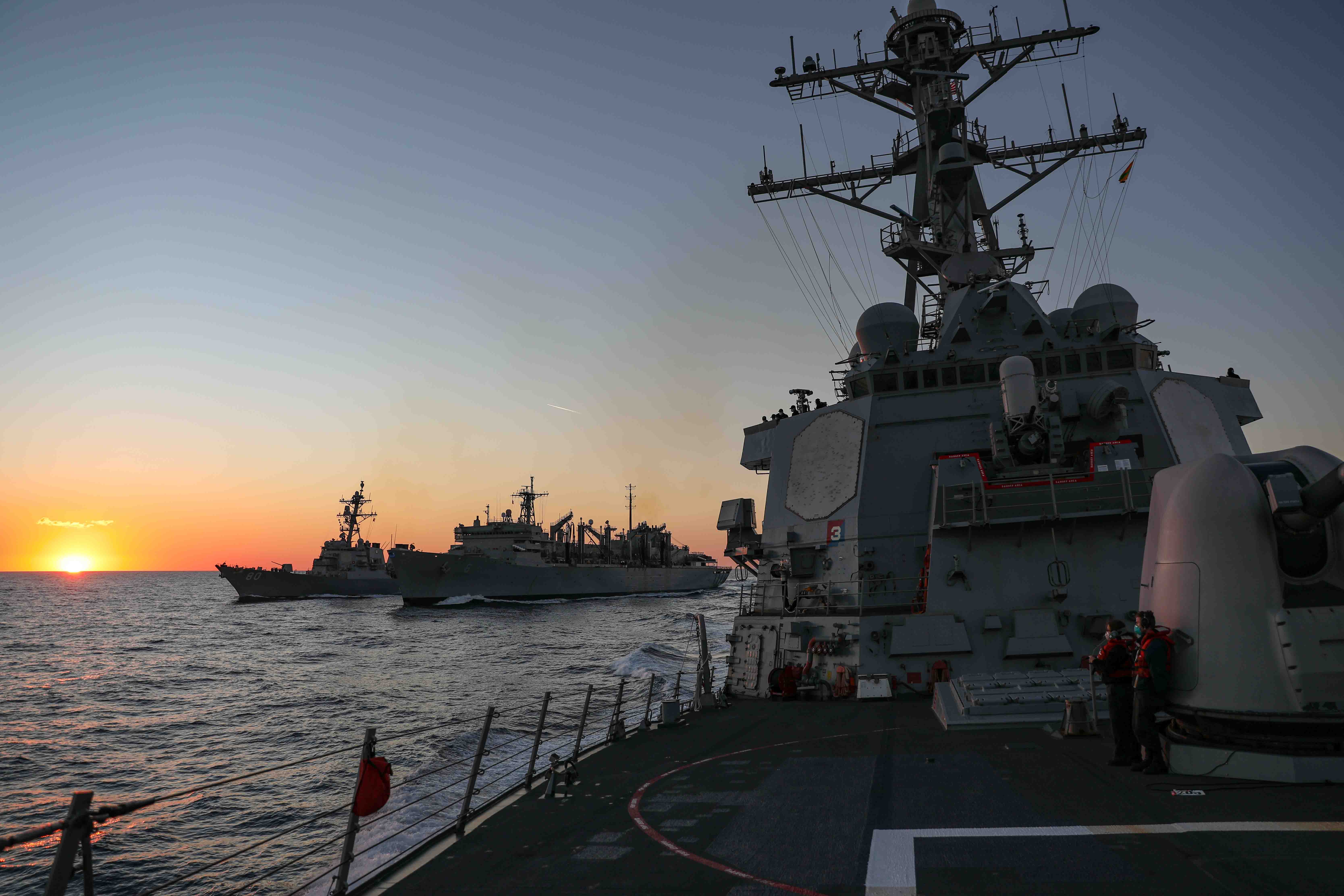 USS Ross (DDG 71), right, breaks away from USNS Supply (T-AOE 6) and USS Roosevelt (DDG 80) during a replenishment in the Mediterranean Sea.