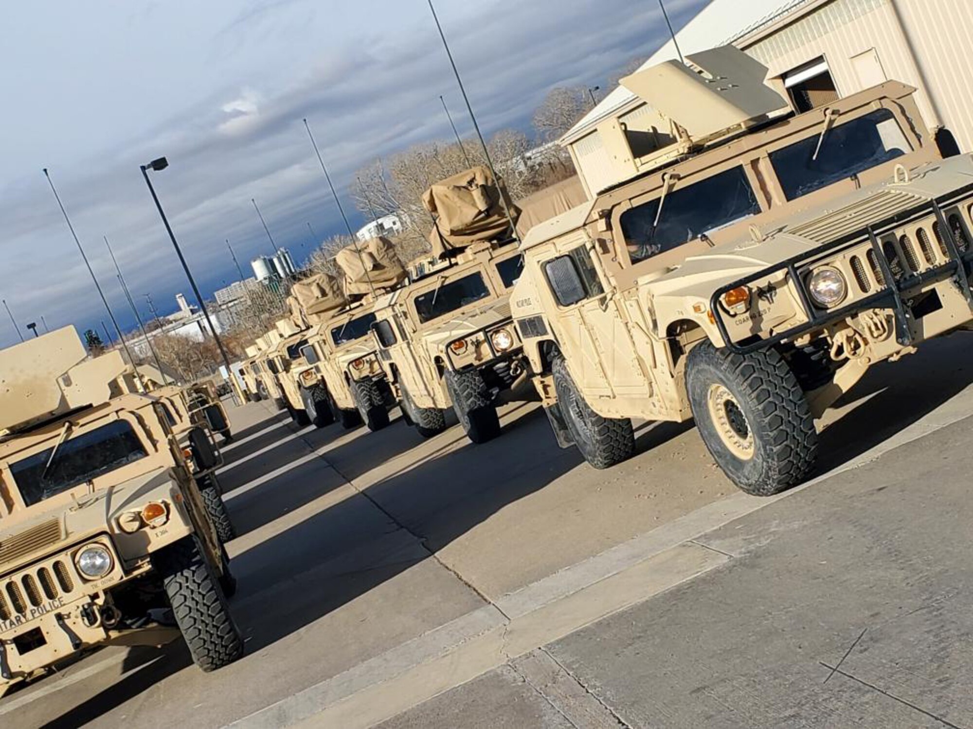 Colorado National Guard High Mobility Multipurpose Wheeled Vehicles stage at the Denver Armory to support the Boulder County Sheriff with traffic control, security operations and evacuation of people displaced by the Marshall Fire in Boulder County, Colorado, Dec. 31, 2021.