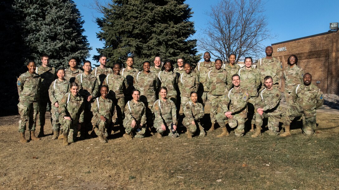 multiple military members stand together for a group photo