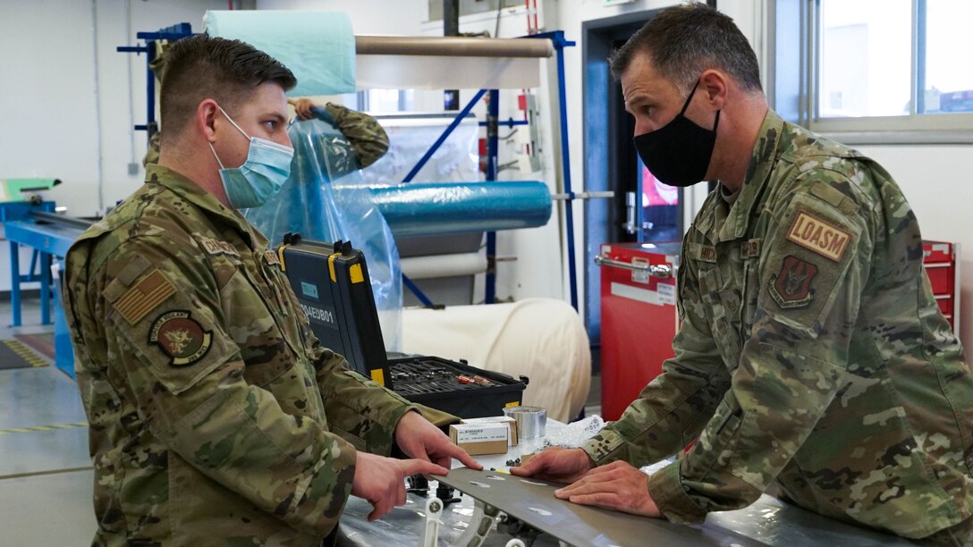 U.S. Air Force Staff Sgt. Matt Hicks and U.S Air Force Staff Sgt. Devon Charmichael coordinate the maintenance on a low observable F-35 Aircraft panel at the 388th MXS Squadron at Hill Air Force Base.