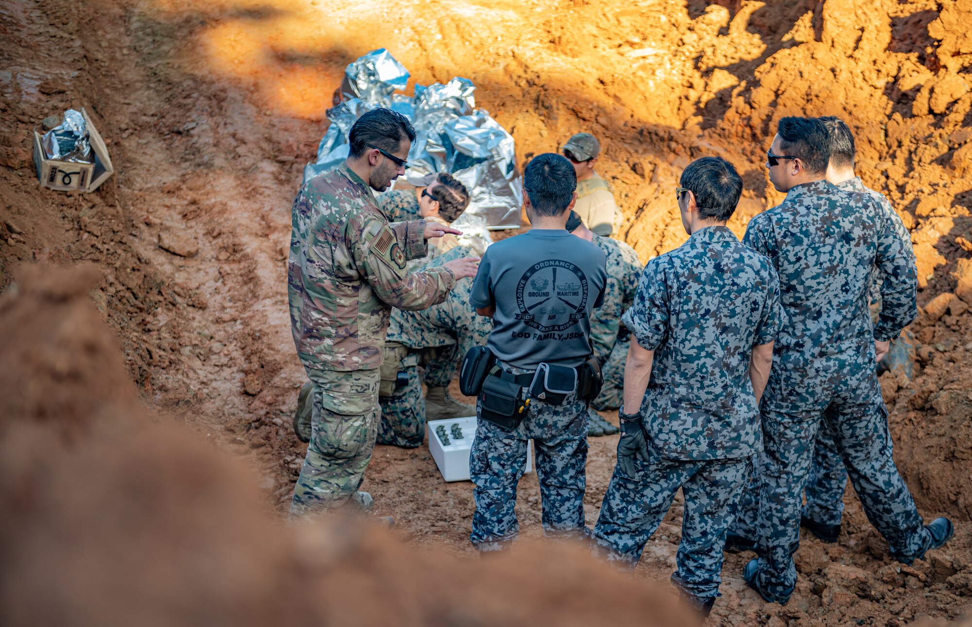 An Airman speaks to members of the Japan Air Self-Defense Force.