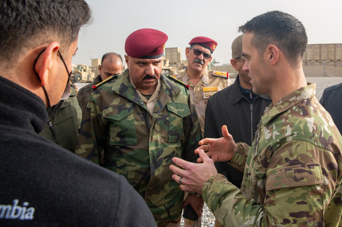 Col. Andrew Steadman, commander, Task Force Raider, talks to Lt. Gen. Abdul Amir Al-Shammari, deputy commander of the Joint Operations Command for Iraq, about divestment initiatives to ensure a lasting defeat of Daesh, at Erbil Air Base, Iraq, Dec. 21, 2021. Less than two weeks after the governments of Iraq and the United States announced the successful transition from combat to an advise, assist, and enable role, key Iraqi government and military officials visited two Iraqi bases, where Coalition forces are invited guests, to observe the new mission first-hand. (U.S. Army photo by Sgt. Matthew Marsilia)