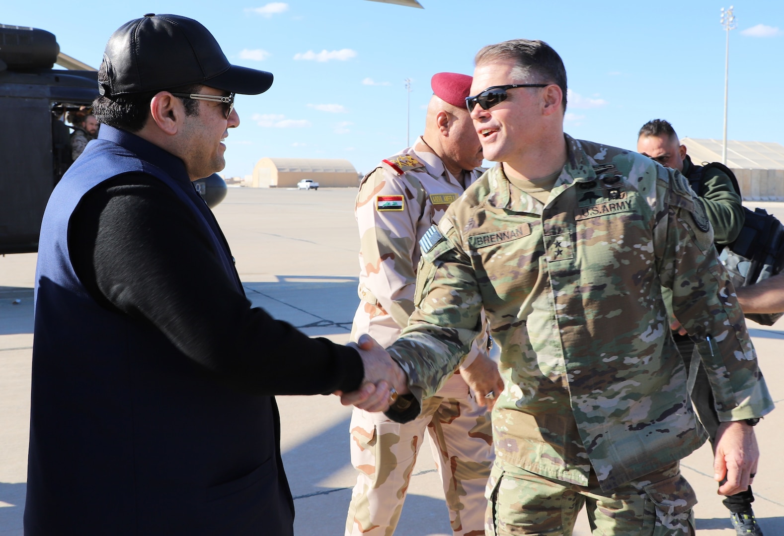 Maj. Gen. John W. Brennan, Jr., CJTF-OIR commander, greets Mr. Qasim al-Araji, National Security Advisor of Iraq upon arrival at Al Asad Air Base on Dec. 18, 2021. Al-Araji and his team visited Al Asad Air Base to assess the coalition’s transition from a combat role to advise, assist and enable. (U.S. Army photo Maj. Alexa Carlo-Hickman)