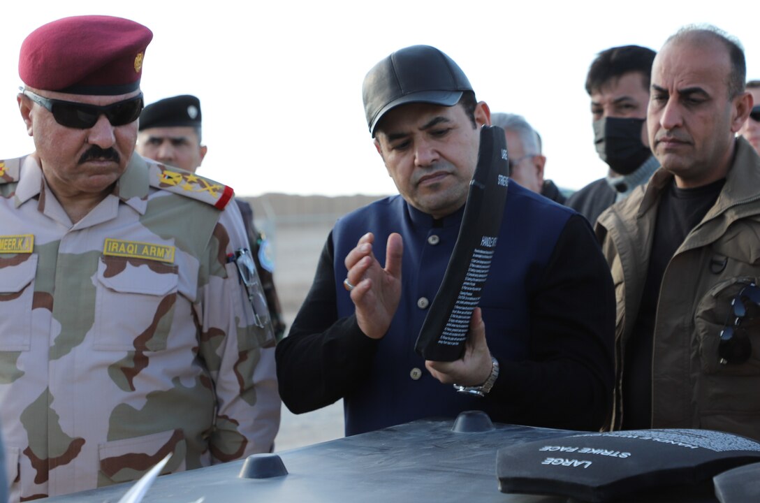 Mr. Qasim al-Araji, National Security Advisor of Iraq and Iraqi Staff Lt. Gen. Abdul Amir al-Shammari, deputy commander, Joint Operations Command for Iraq inspect body armor plates at an equipment staging area at Al Asad Air Base on Dec. 18, 2021. Millions of dollars of equipment, supplies, weapons and ammunition are transferred to Iraq forces to assist and enable their continuing mission to defeat Daesh. (U.S. Army photo Maj. Alexa Carlo-Hickman)