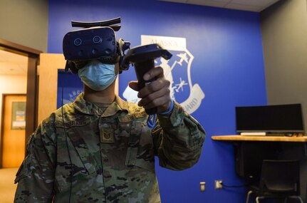 Tech. Sgt. Esdei Arurang, 176 Maintenance Group unit training manager, launches a training module at the 176th MXG Virtual Reality Training Lab at Joint Base Elmendorf-Richardson, Alaska, Dec. 4, 2021. The lab is one of the first facilities of its kind in the Air National Guard, and the innovative training allows Airmen to familiarize themselves with infrequent maintenance procedures.