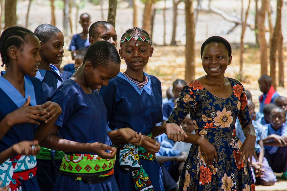 Students at a local school in Lamu County, Kenya, welcome U.S. service members with song and dance during a cultural exchange engagement, Nov. 2, 2021. Combined Joint Task Force – Horn of Africa’s (CJTF-HOA) efforts, as part of a comprehensive whole-of-government approach, are aimed at increasing African partner nations’ capacity to maintain a stable environment, with an effective government that provides a degree of economic and social advancement to its citizens.