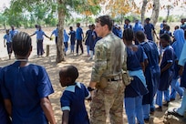 U.S. Army Sgt. Andrew Lerman with Charlie Company, 1-102nd Infantry Regiment (Mountain), Task Force Iron Gray, Combined Joint Task Force – Horn of Africa (CJTF-HOA), participates in a game with students during a cultural engagement at a school in Lamu County, Kenya, Nov. 2, 2021. CJTF-HOA efforts, as part of a comprehensive whole-of-government approach, are aimed at increasing African partner nations’ capacity to maintain a stable environment, with an effective government that provides a degree of economic and social advancement to its citizens.