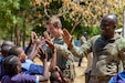 U.S. Army Sgt. Connor Dowd and Sgt. 1st Class Gregory Reid with C Company, 1-102nd Infantry Regiment (Mountain), Task Force Iron Gray, Combined Joint Task Force – Horn of Africa (CJTF-HOA), high-five students during a cultural engagement at a school in Lamu County, Kenya, Nov. 2, 2021. CJTF-HOA’s efforts, as part of a comprehensive whole-of-government approach, are aimed at increasing African partner nations’ capacity to maintain a stable environment, with an effective government that provides a degree of economic and social advancement to its citizens.