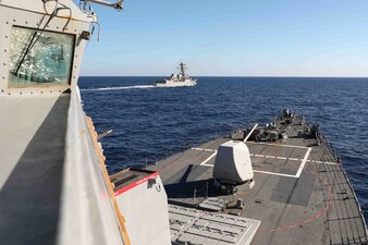 USS Gravely (DDG 107), back, participates in a photo exercise with USS Ross (DDG 71) in the Mediterranean Sea.