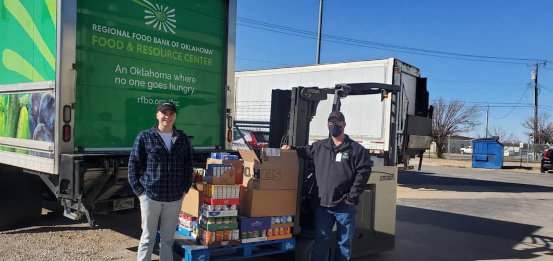 Soldiers with the 700th Brigade Support Battalion, 45th Infantry Brigade Combat Team pose with some of the more than 670 pounds of food items the battalion donated to a local food bank during December 2021. (Photo provided by 700th Support Battalion)