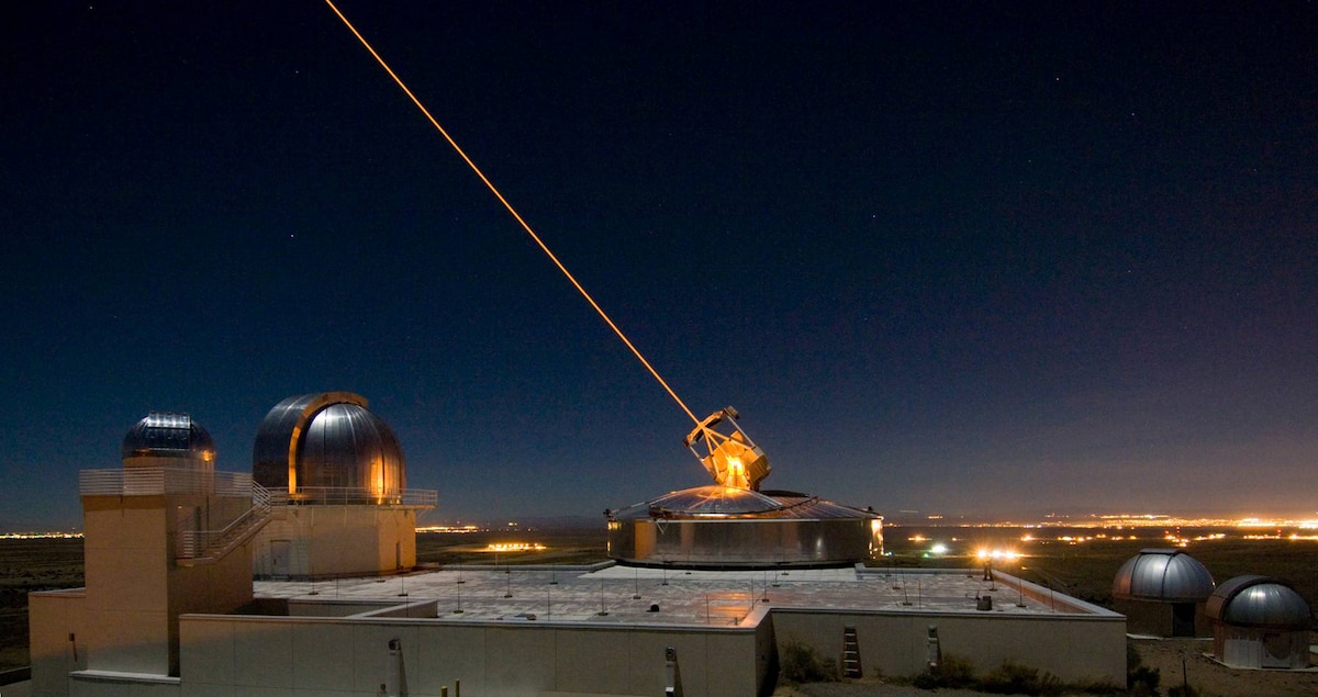AFRL’s 3.5 meter telescope on Kirtland AFB, N.M. uses its laser to produce a guide star for a reference for adaptive optics, and previously held the record for the smallest telescope to image an asteroid’s satellite. The larger of the two domes to its left houses the 1.5 meter telescope, which now holds the record, without using a laser. (US Air Force photo/Robert Fugate)