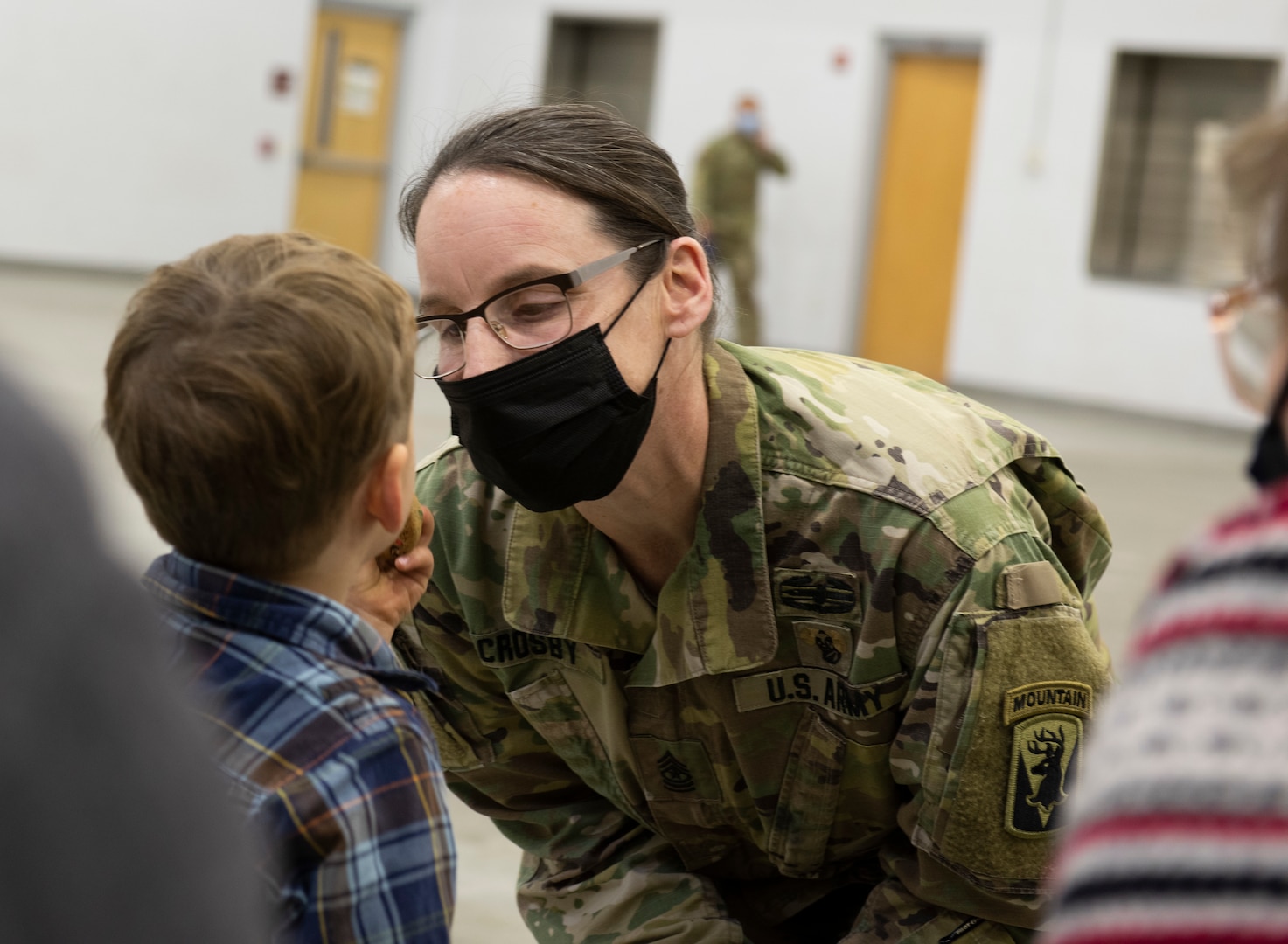 Command Sgt. Maj. Melinda Crosby, incoming command sergeant major for the 186th Brigade Support Batallion, 86th Infantry Combat Team (Mountain), speaks with her son, Marcus, prior to the change of responsibility ceremony in Northfield, Vermont, Dec. 4, 2021. Crosby succeeds Command Sgt. Maj. Allen King, who is retiring after 38 years of service. (U.S. Army National Guard photo by Don Branum)