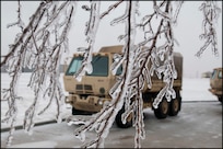 (File photo) Ice covers trees, parking lots and the ground while light medium tactical vehicles are staged at the Oklahoma Highway Patrol station at Perry, Okla., Dec. 28. The tactical vehicles are used by Soldiers of the 45th Infantry Brigade Combat team to assist the Highway Patrol in rescuing and transporting stranded motorists during the severe winter storm affecting much of the Southwestern United States. (U.S. Army photo by Sgt. Anthony Jones)