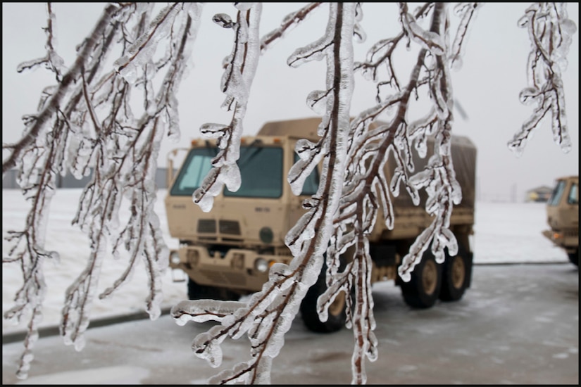 (File photo) Ice covers trees, parking lots and the ground while light medium tactical vehicles are staged at the Oklahoma Highway Patrol station at Perry, Okla., Dec. 28. The tactical vehicles are used by Soldiers of the 45th Infantry Brigade Combat team to assist the Highway Patrol in rescuing and transporting stranded motorists during the severe winter storm affecting much of the Southwestern United States. (U.S. Army photo by Sgt. Anthony Jones)
