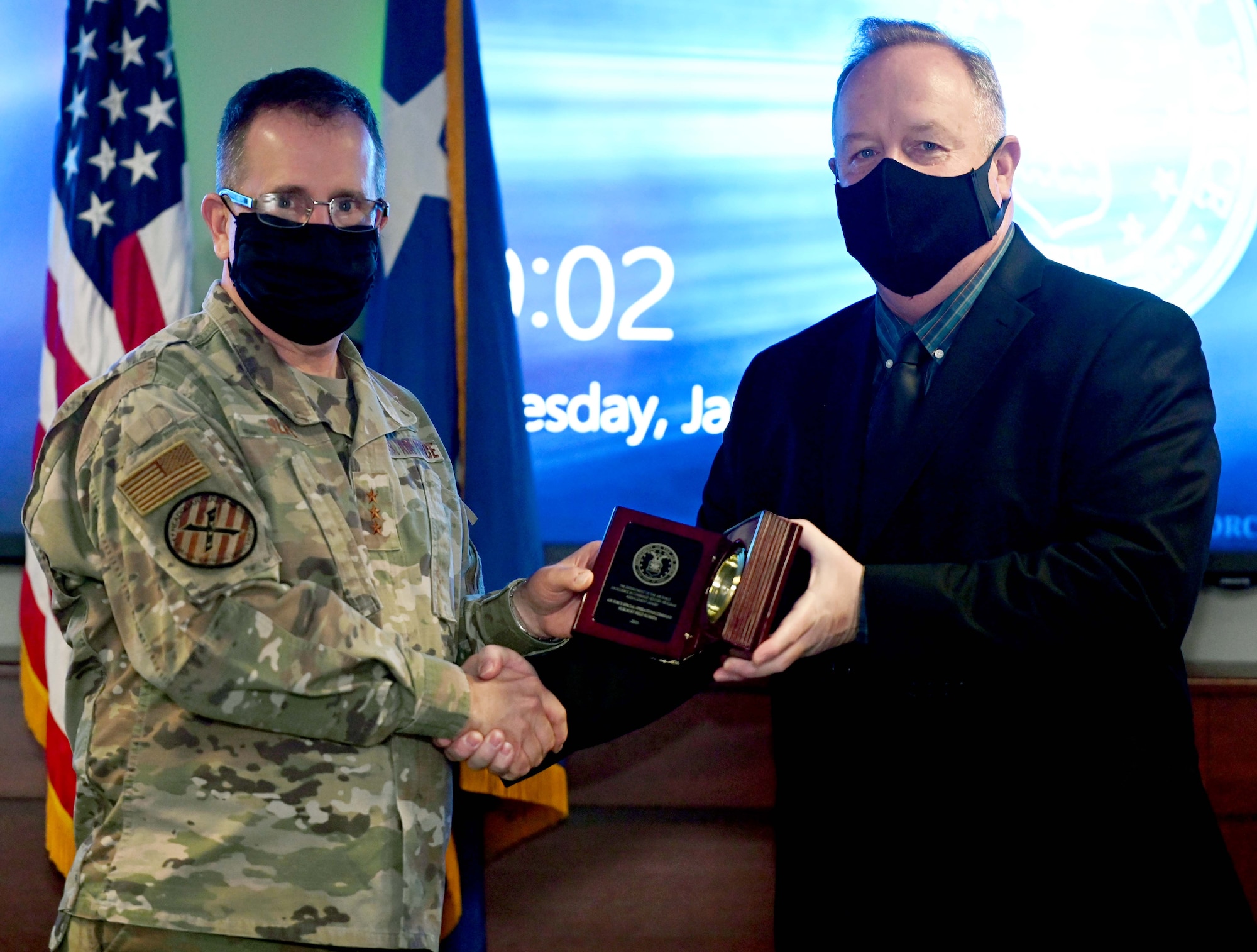 Lt. Gen. Jim Slife, commander of Air Force Special Operations Command, presents the Department of the Air Force’s Excellence in Command History Program Management Award to Eric Witt, AFSOC deputy command historian, at Hurlburt Field, Fla., Jan. 4, 2022. The AFSOC History Office was recognized as the best primary or field command history office for outstanding history and heritage programs leadership that provided exemplary historical services to improve organizational effectiveness, esprit de corps, and combat capability. (U.S. Air Force photo by Staff Sgt. Brandon Esau)