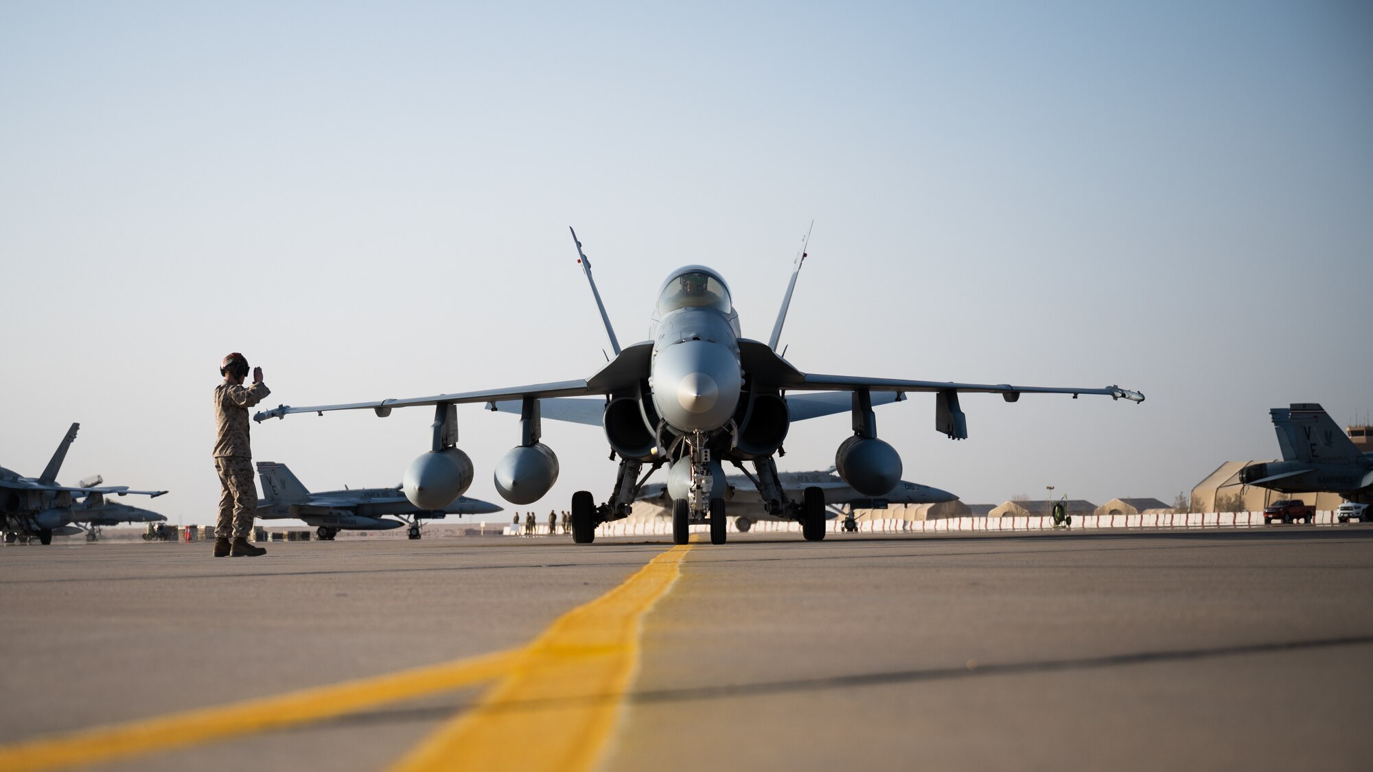 A U.S. Marine F/A-18 Hornet taxis on the flight line at Prince Sultan Air Base, Kingdom of Saudi Arabia, Dec. 23, 2021. The arrival of the Marine Fighter Attack Squadron 115 is a key addition to PSAB as it prepares and postures U.S. and coalition forces to span the full range of combat effectiveness. (U.S. Air Force photo by Senior Airman Jacob B. Wrightsman)