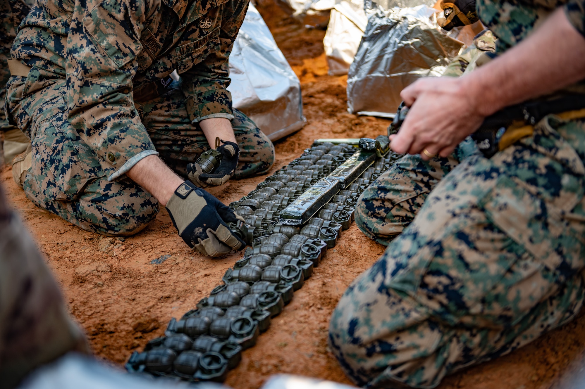 U.S. Marine Corps explosive ordnance disposal technicians prepare grenades for disposal.