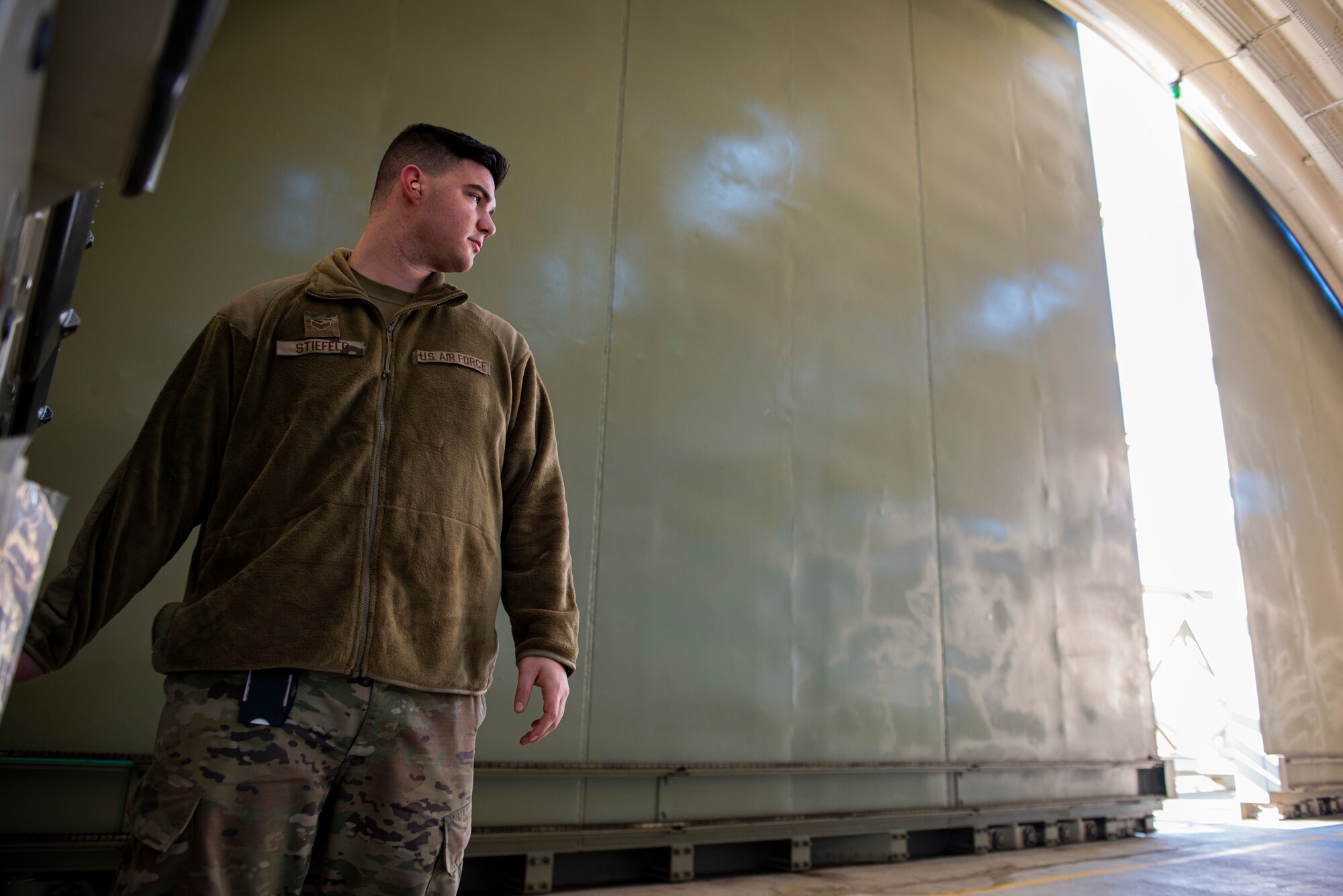 Senior Airman Austin Stiefeld, a special weapons technician assigned to the 39th Maintenance Squadron, opens a hangar at Incirlik Air Base, Turkey, Dec. 21, 2021.