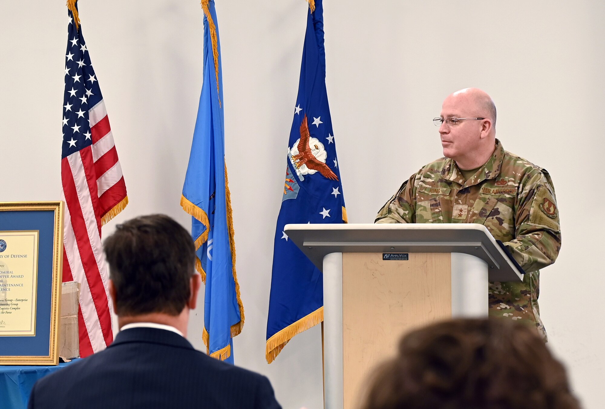 Man at podium with audience in foreground