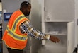 A staff member of the U.S. Army Medical Materiel Center – Europe opens up a warehouse super cooler capable of maintaining temperatures at -80 degrees Celsius, which is required for some COVID vaccines. (Ellen Crown, US Army Released)