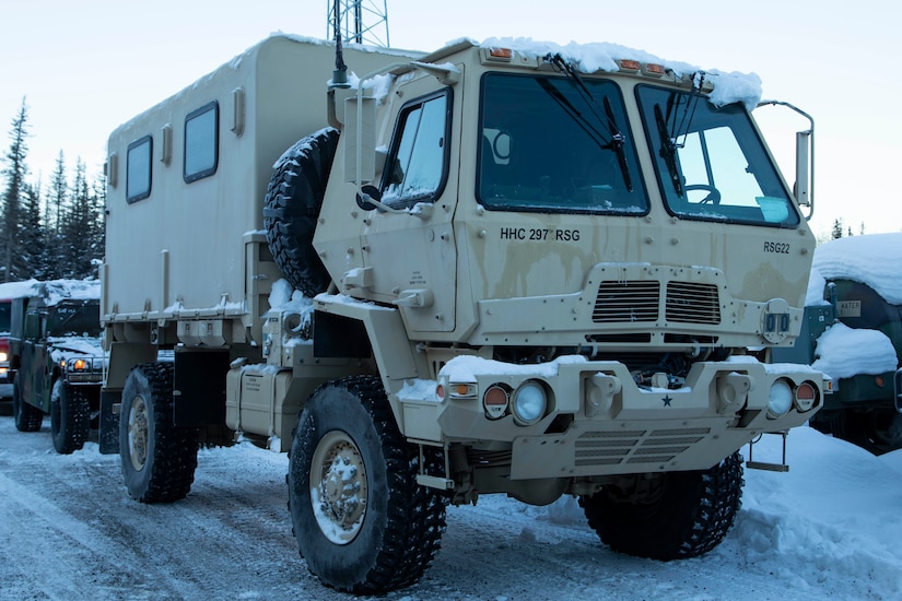 A Light Medium Tactical Vehicle and a High Mobility Multipurpose Wheeled Vehicle warm up at the Alaska National Guard Armory on Joint Base Elmendorf-Richardson, Alaska, prior to transport to Alcantra Armory in Wasilla, Jan. 5. The LMTV and HMMWV have been assigned to Alaska Army National Guard's 297th Regional Support Group to provide direct support to the Matsu-Borough after high winds have led to infrastructure damage, power outages, and dangerous transportation conditions. (U.S. Army National Guard photo by Victoria Granado)