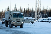 A Light Medium Tactical Vehicle and a High Mobility Multipurpose Wheeled Vehicle leaves the Alaska National Guard Armory on Joint Base Elmendorf-Richardson, Alaska, for transport to the Alcantra Armory in Wasilla, Jan. 5. The LMTV and HMMWV have been assigned to Alaska Army National Guard's 297th Regional Support Group to provide direct support to the Matsu-Borough after high winds have led to infrastructure damage, power outages, and dangerous transportation conditions. (U.S. Army National Guard photo by Victoria Granado)