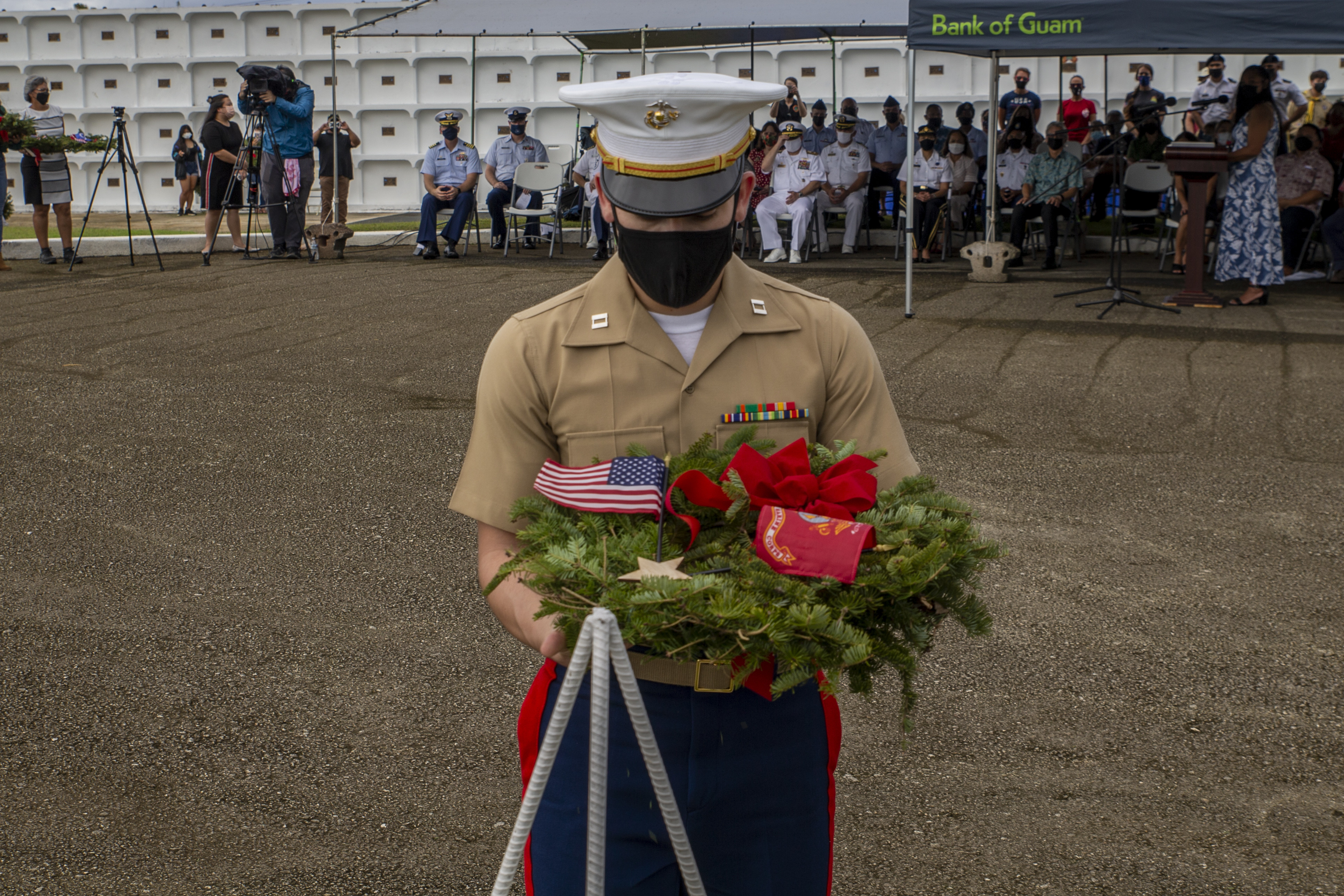U.S. Marine Corps Capt. Joshua Oblea, the Marine Corps Base Camp Blaz communications officer, prepares to place the Marine Corps wreath during a Wreaths Across America ceremony at Guam Veterans Cemetery in Piti, Guam, Dec. 18, 2021.