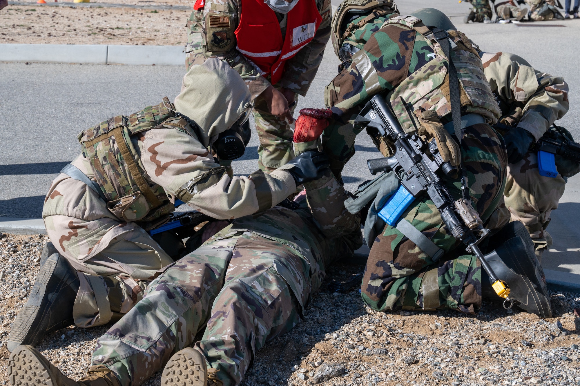 412th Security Forces Squadron Airmen treat an injured teammate during the Operation Alert Jackal deployment readiness exercise on Edwards Air Force Base, California, Dec. 2. (Air Force photo by Katherine Franco)