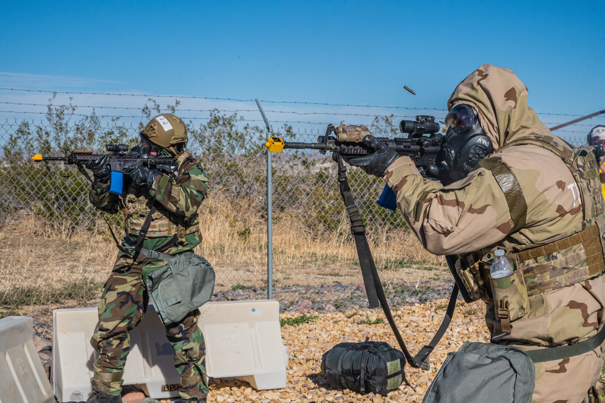 412th Security Forces Squadron Airmen return fire to enemy combatants during the Operation Alert Jackal deployment readiness exercise on Edwards Air Force Base, California, Dec. 2. (Air Force photo by Katherine Franco)