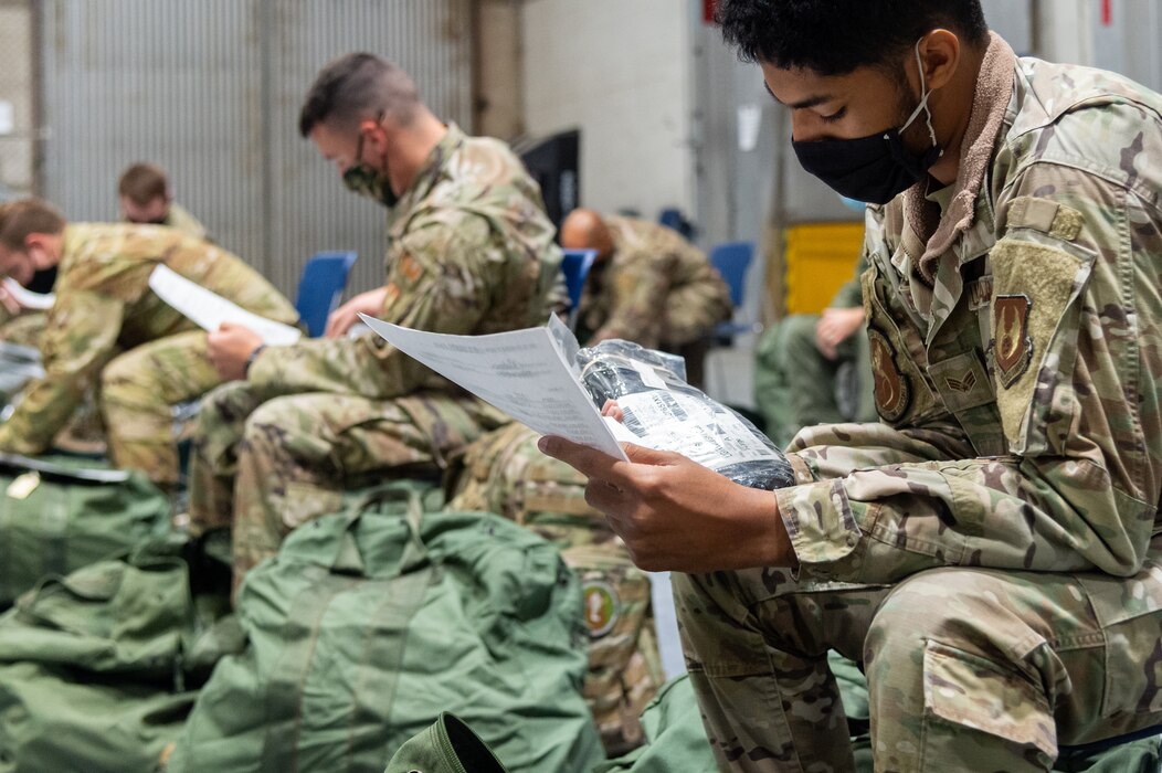 Airmen from the 412th Security Forces Squadron verify their equipment during the Personnel Deployment Function line portion of the the Operation Alert Jackal deployment readiness exercise on Edwards Air Force Base, California, Nov. 30. (Air Force photo by Chloe Bonaccorsi)