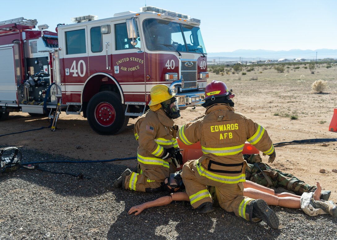 Firefighters from the 812th Civil Engineers Squadron's Fire and Emergency Services respond to a simulated victim during the Operation Alert Jackal deployment readiness exercise on Edwards Air Force Base, California, Dec. 2. (Air Force photo by Chloe Bonaccorsi)
