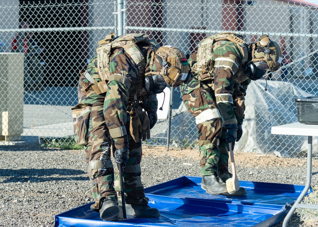 Airmen from the 412th Security Forces Squadron decontaminate their MOPP (Mission Oriented Protective Posture) gear during the Operation Alert Jackal deployment readiness exercise on Edwards Air Force Base, California, Dec. 2. (Air Force photo by Chloe Bonaccorsi)