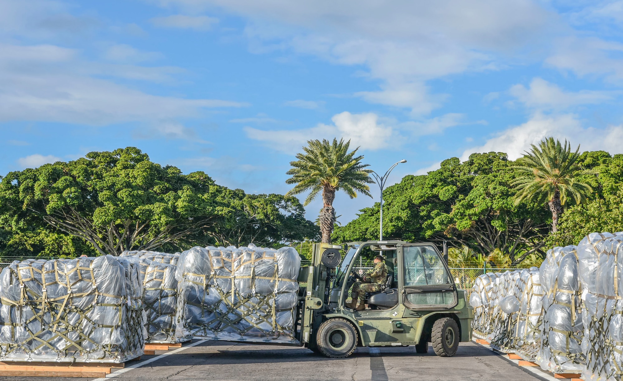 647th Logistics Readiness Squadron Airmen repositions a charcoal filter pallet in the cargo deployment function yard at Joint Base Pearl Harbor-Hickam, Hawaii, Dec. 22, 2021. 647th LRS recieved a total of 15 pallets of charcoal filters weighing 75 tons from a C-5 Super Galaxy in support of the water recovery efforts on Oahu.  (U.S. Air Force photo by Tech. Sgt. Anthony Nelson Jr.)