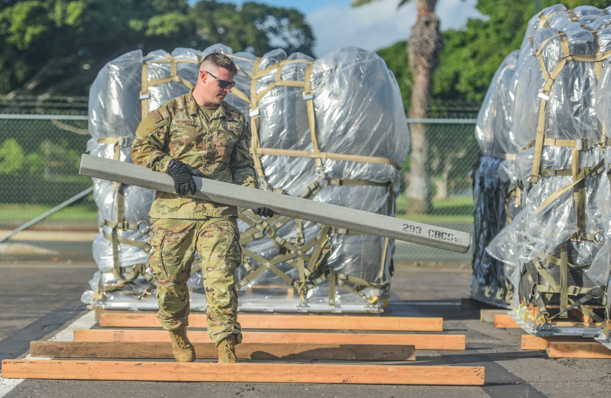 U.S. Air Force Staff Sgt. Kevin Mcgauley, 647th Logistics Readiness Squadron combat mobility flight team chief, positions dunnage for 463L pallets at Joint Base Pearl Harbor-Hickam, Hawaii, Dec. 22, 2021. 647th LRS recieved a total of 15 pallets of charcoal filters weighing 75 tons in support of the water recovery efforts on Oahu.   (U.S. Air Force photo by Tech. Sgt. Anthony Nelson Jr.)