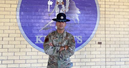 MTI of the year stands in front of 324th TRS shield.