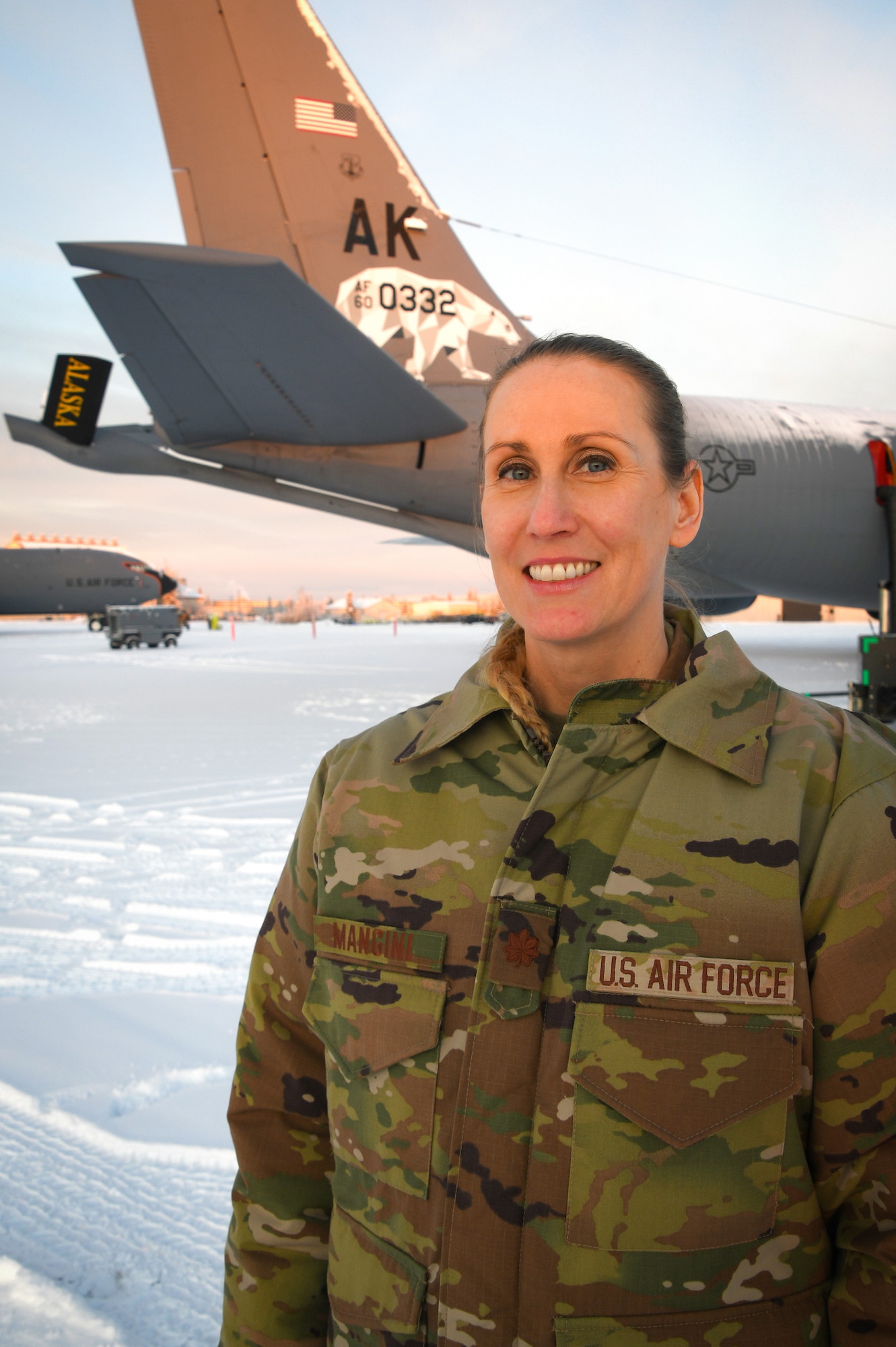 Maj. Elizabeth Mangini, 168th Wing Medical Services Corps officer, takes a photo in front of the 168th Wing's KC-135 Stratotanker at minus twenty degrees while on duty at Eielson Air Force Base. Mangini is assigned to the 168th Medical Group in support of the wing's arctic refueling mission. (U.S. Air National Guard photo by Senior Master Sgt. Julie Avey)