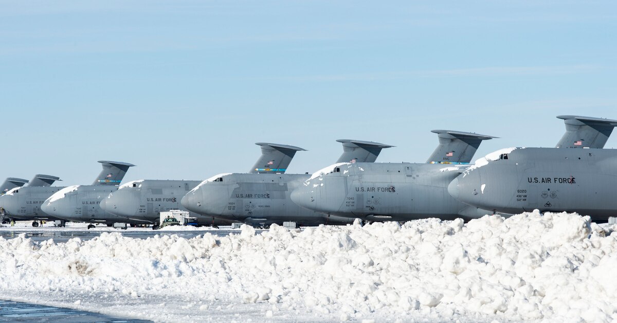 Snow-covered C-5M Super Galaxy aircraft sit on the flight line at Dover Air Force Base, Delaware, Jan. 4, 2022. After Winter Storm Frida dropped eight inches of snow, base personnel worked diligently to resume normal operations. (U.S. Air Force photo by Roland Balik)