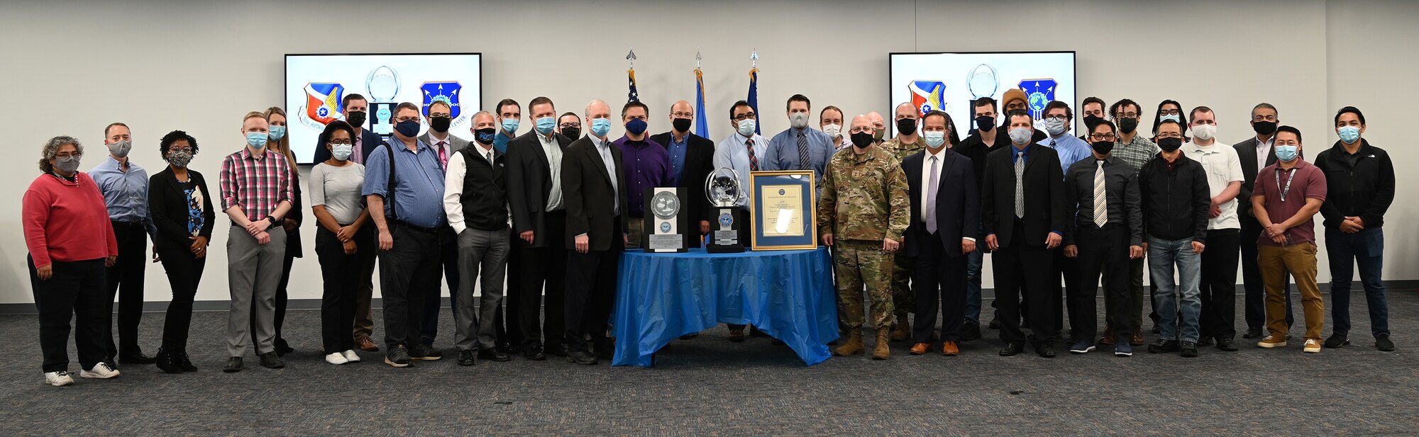 Group of people posing with trophies