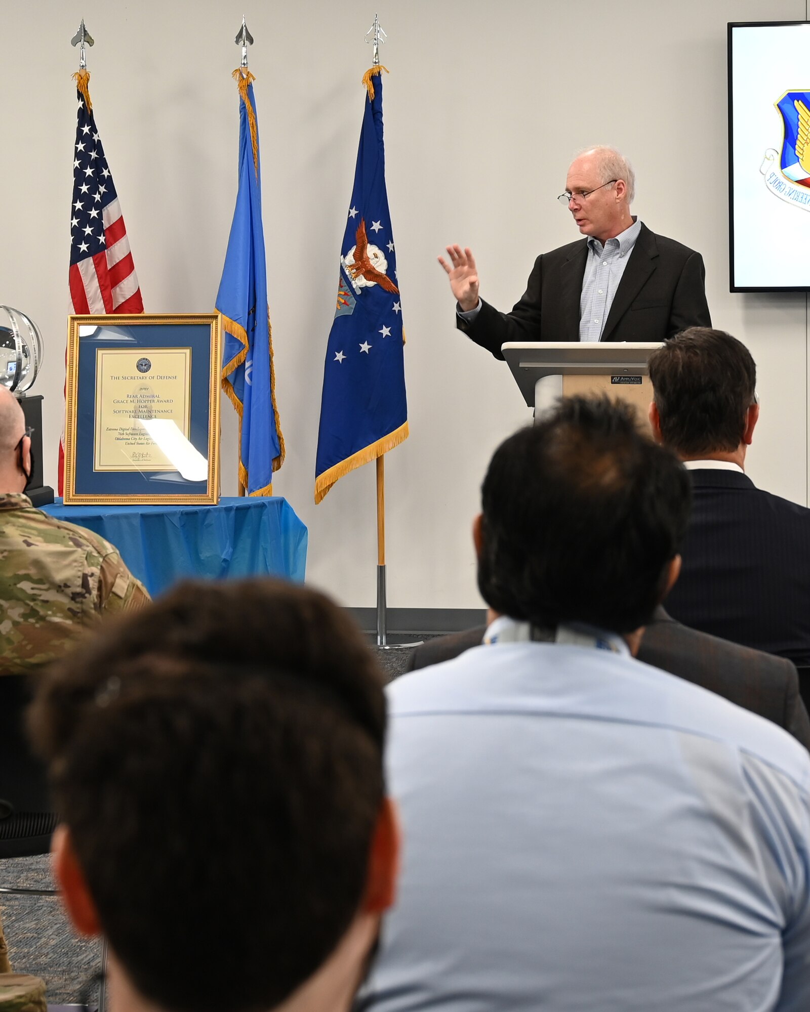 Man at podium with audience in foreground