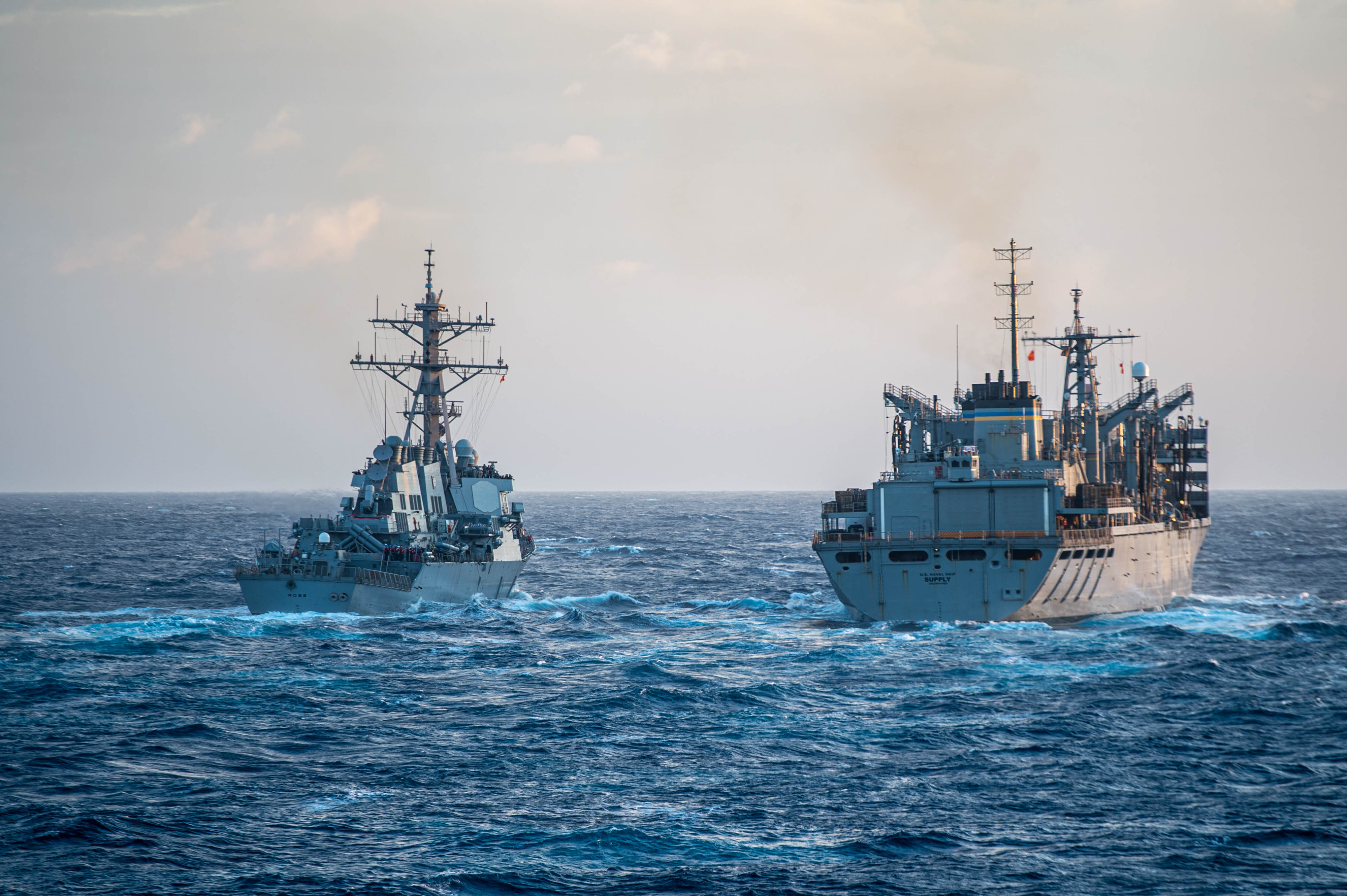 The Arleigh Burke-class guided-missile destroyer USS Ross (DDG 71) approaches the Supply-class fast combat support ship USNS Supply (T-AOE-6) during a replenishment-at-sea, Dec. 19, 2021.