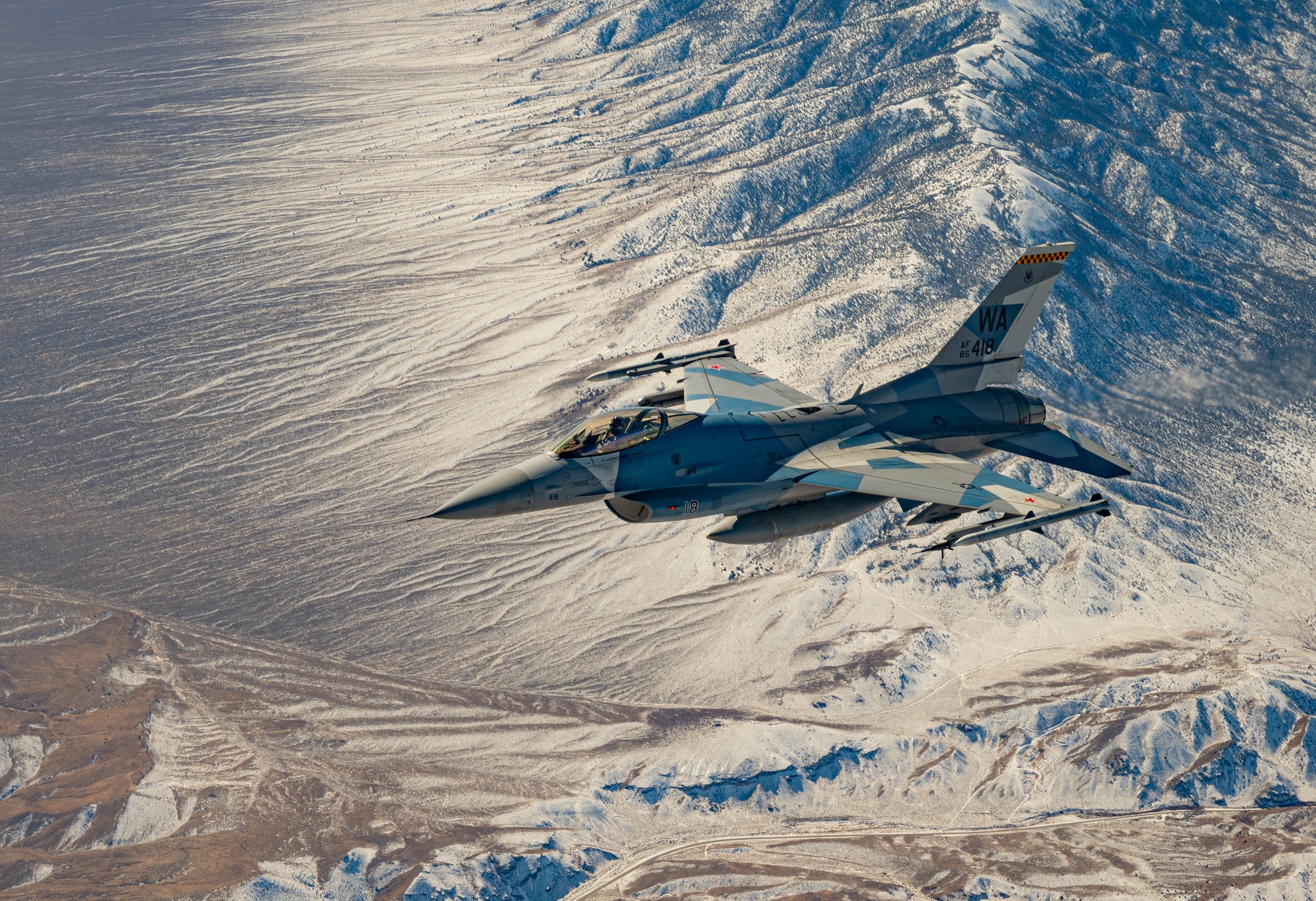 An F-16 Fighting Falcon assigned to the 64th Aggressor Squadron flies over the Nevada Test and Training Range