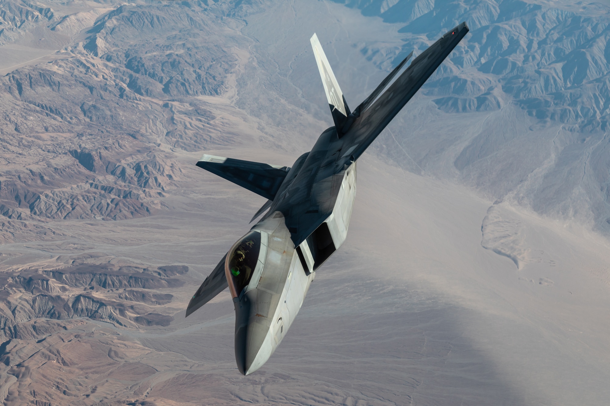 An F-22 Raptor from the 422nd Test and Evaluation Squadron flies over Nellis Air Force Base, Nev.