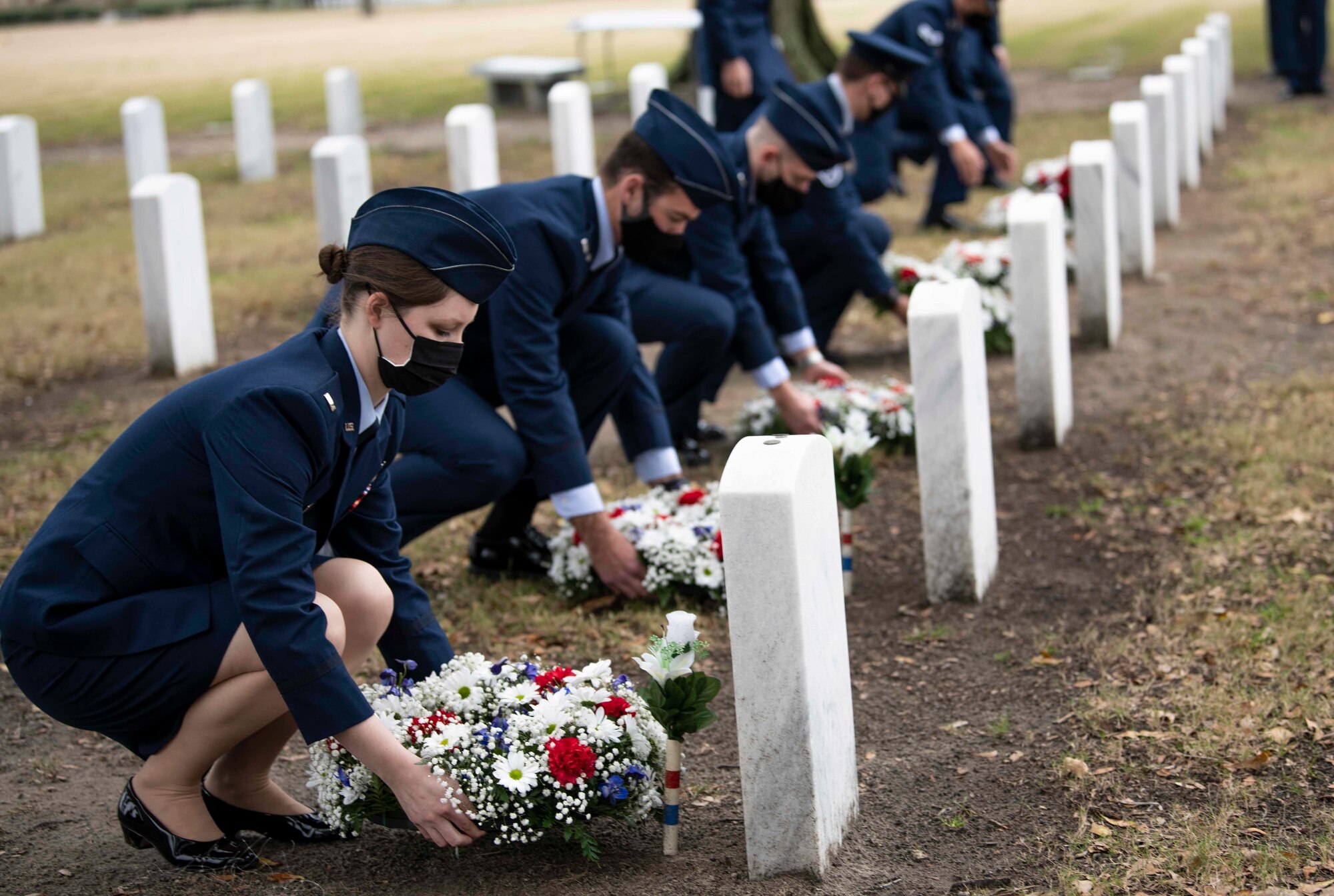 Airmen places wreathes on a graves