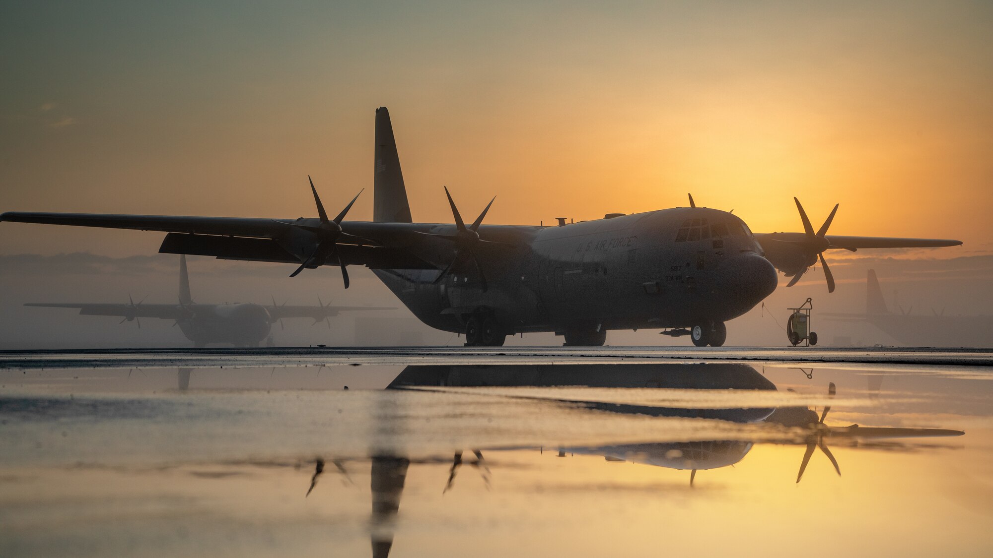 A C-130J Super Hercules sits on the flightline