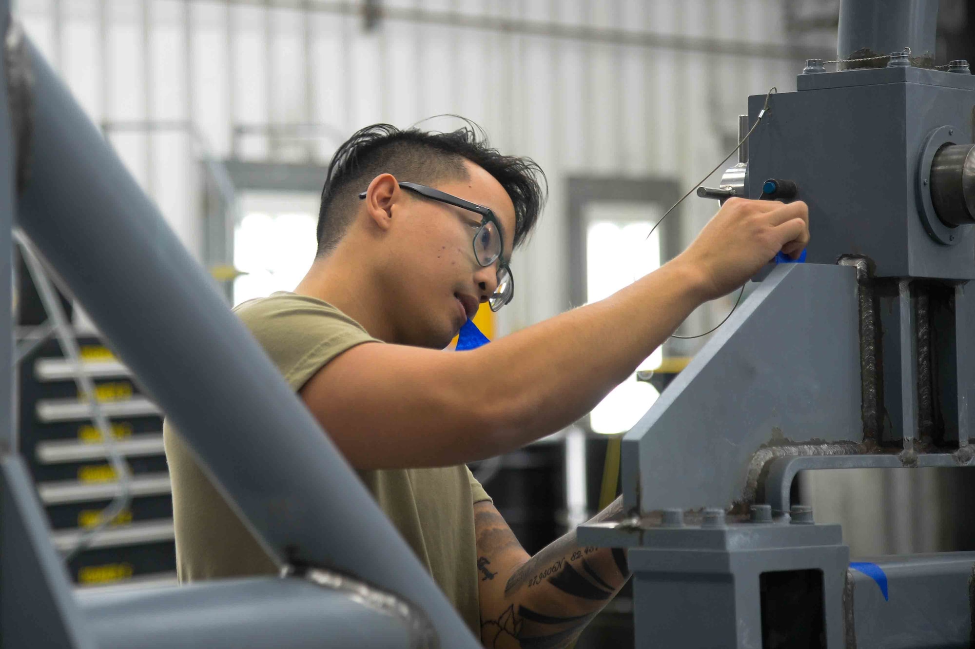 U.S. Air Force Airman 1st Class Evander Esperanza, 388th Maintenance Squadron low observable journeyman, prepares a piece of ground equipment for paint at Hill Air Force Base, Utah