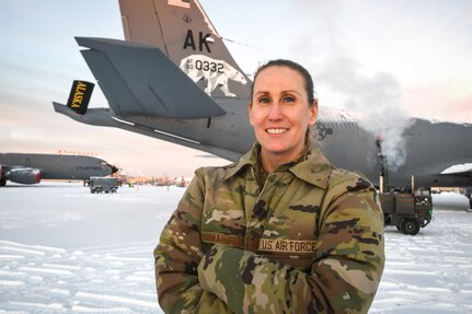 Maj. Elizabeth Mangini, 168th Wing Medical Services Corps officer, takes a photo in front of the 168th Wing's KC-135 Stratotanker at minus twenty degrees while on duty at Eielson Air Force Base. Mangini is assigned to the 168th Medical Group in support of the wing's arctic refueling mission. (U.S. Air National Guard photo by Senior Master Sgt. Julie Avey)