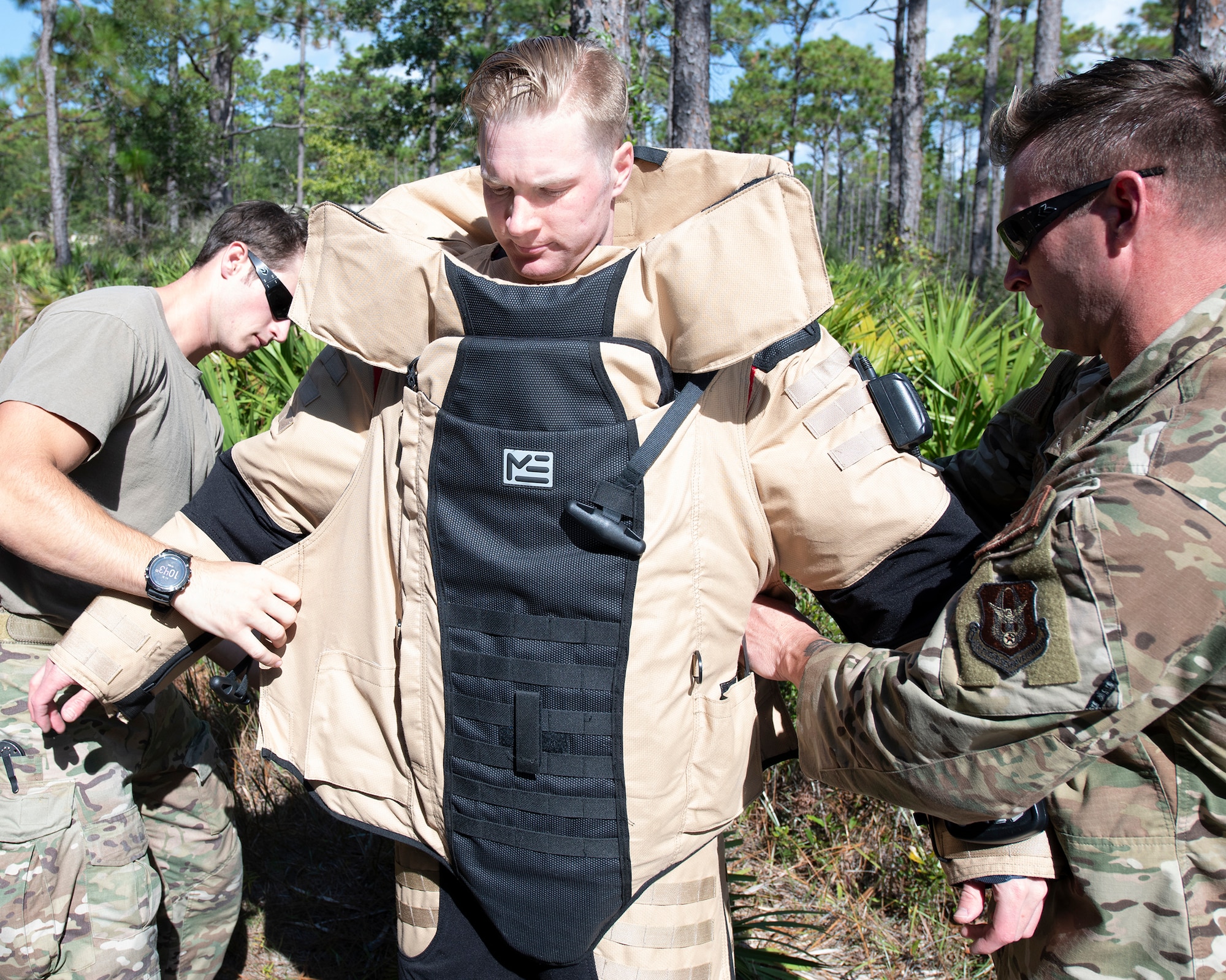 An EOD tech dons on a protective, bomb suit during an IED training scenario.