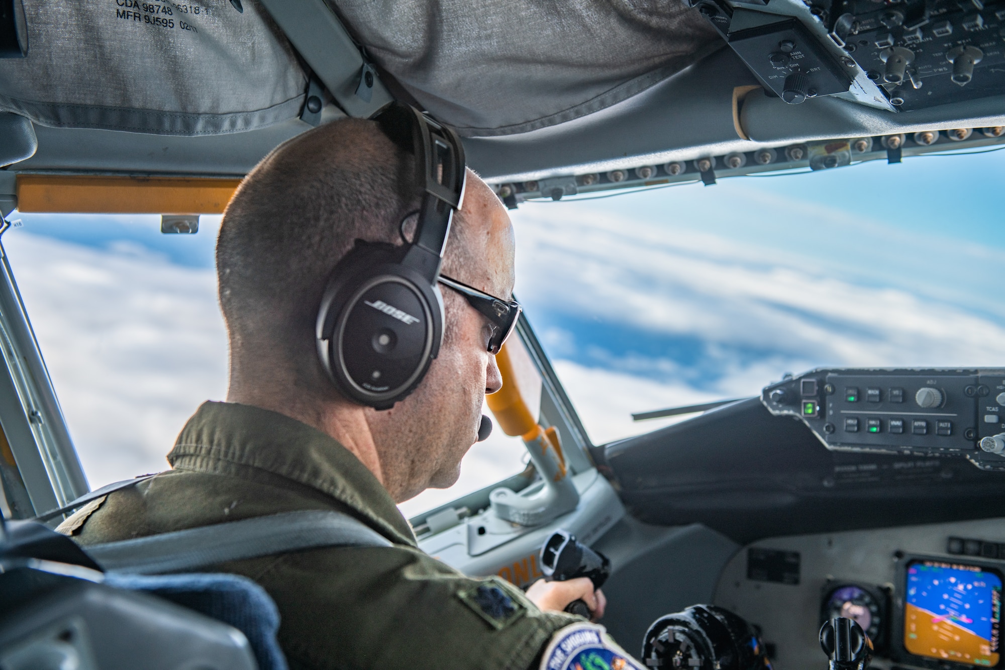 A pilot checks his instruments in the cockpit