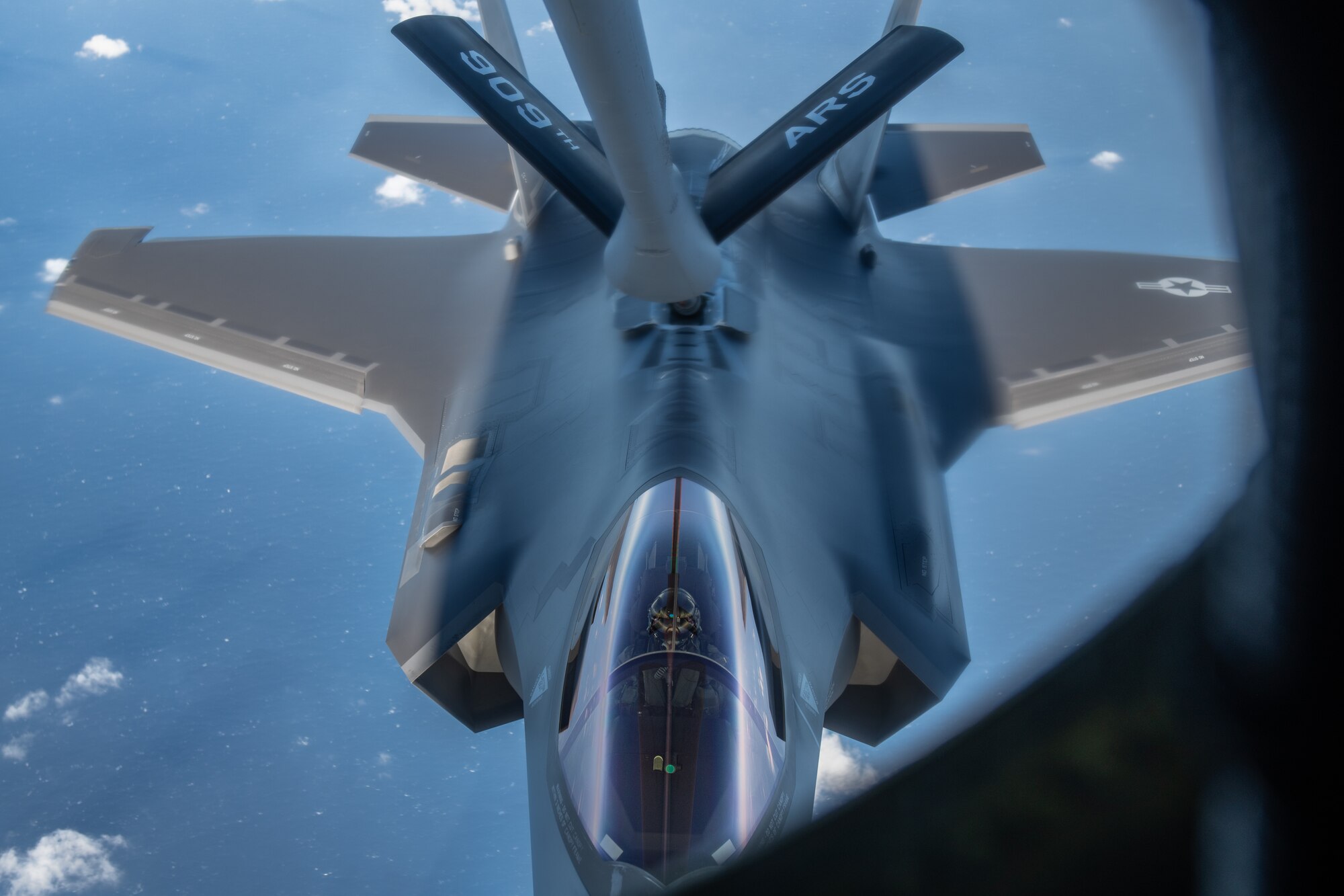 A jet gets refueled by a plane midair